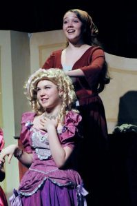 Cinderella (Tatum Ludlam) prepares Florinda's (Clair Leon) hair.(Studio East)
